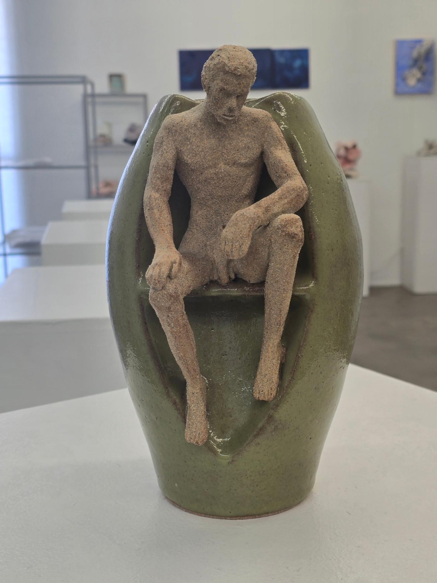 Figurative green vessel with seated figure