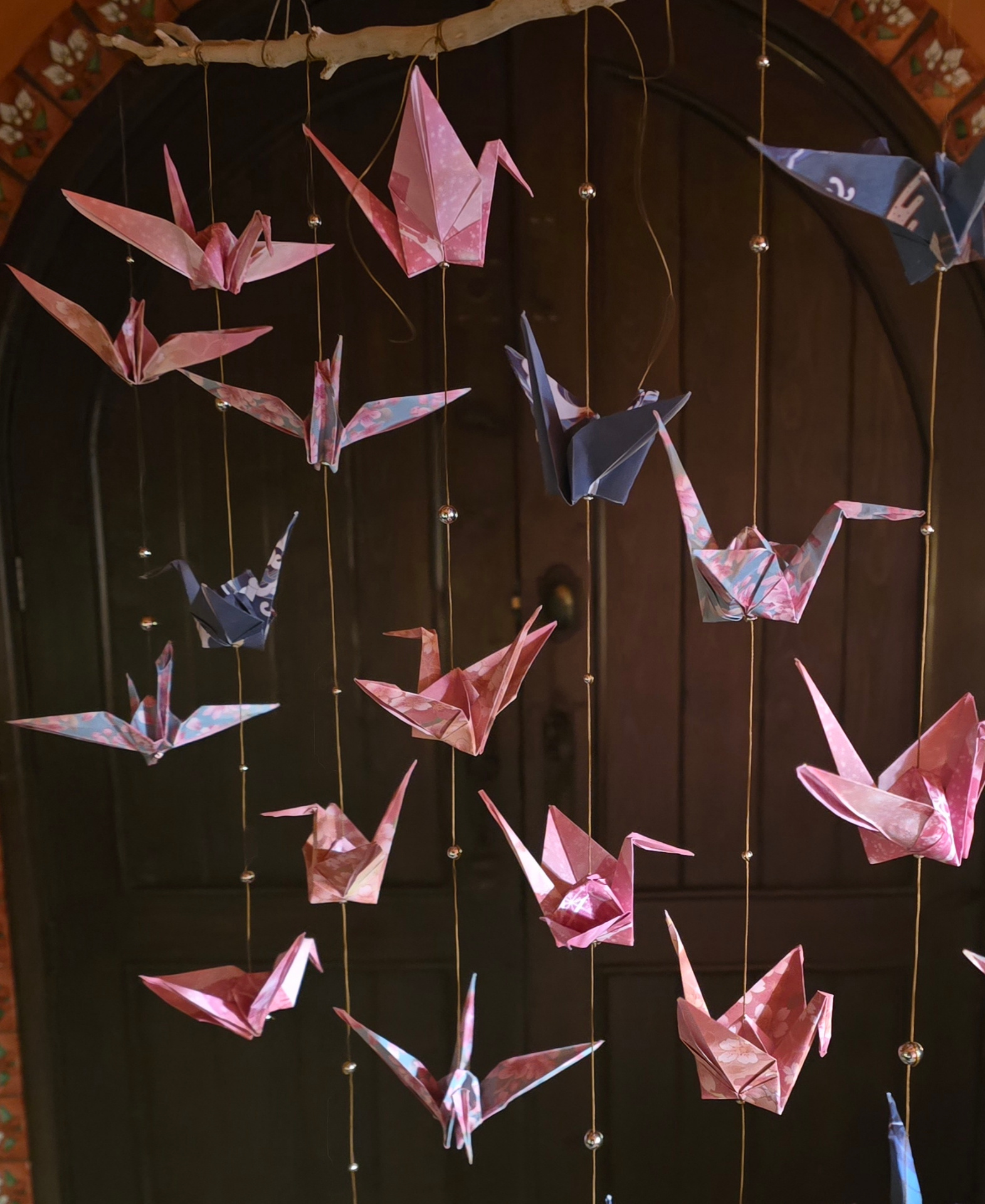 Origami crane mobile in cherry-blossom papers