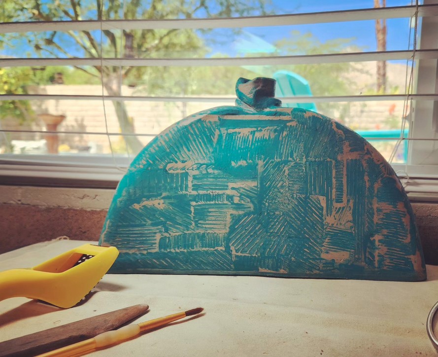 Robby — carved teal half-dome sculpture in progress