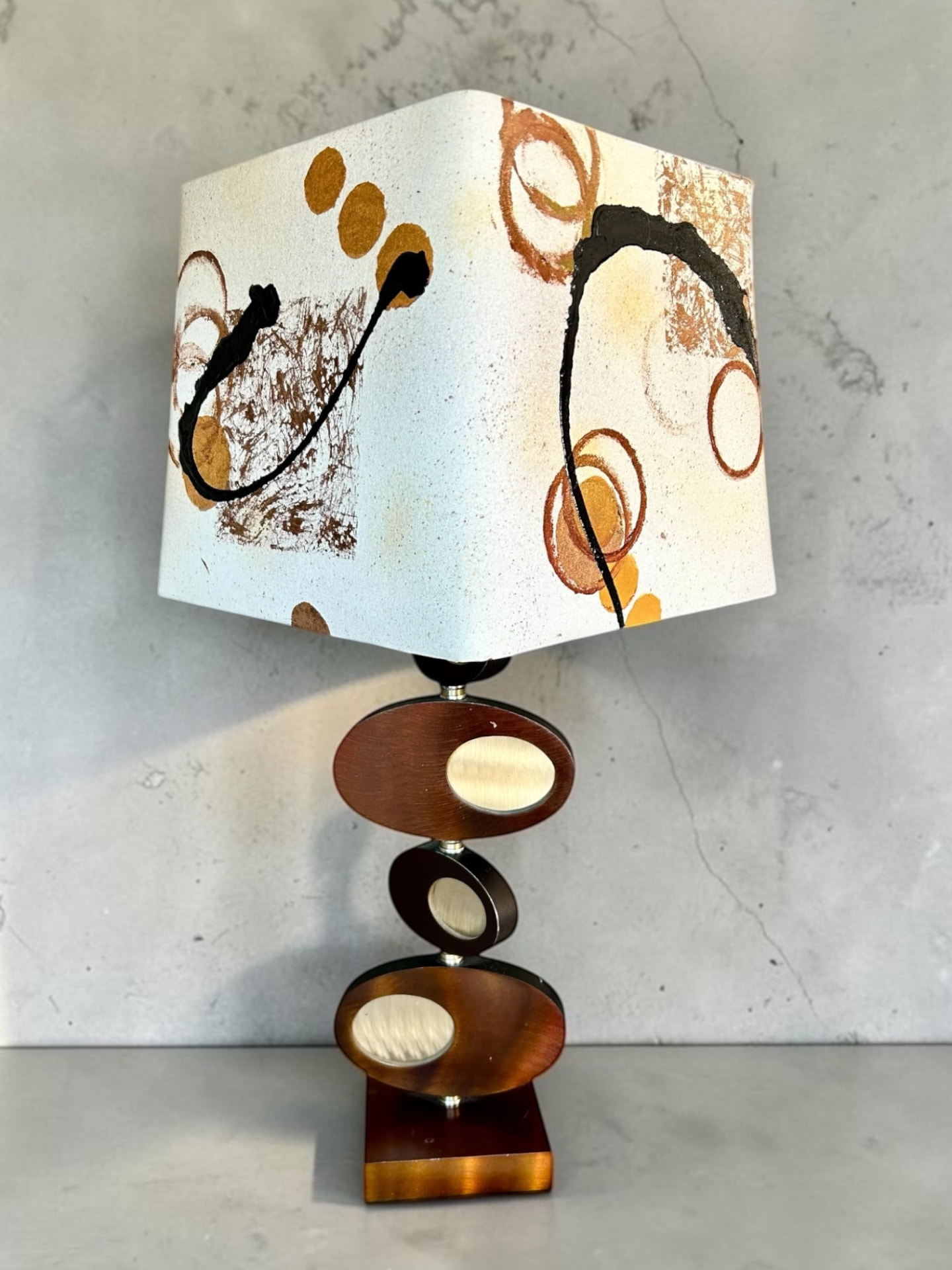 Midcentury modern lamp with abstract patterned shade and stacked wooden base