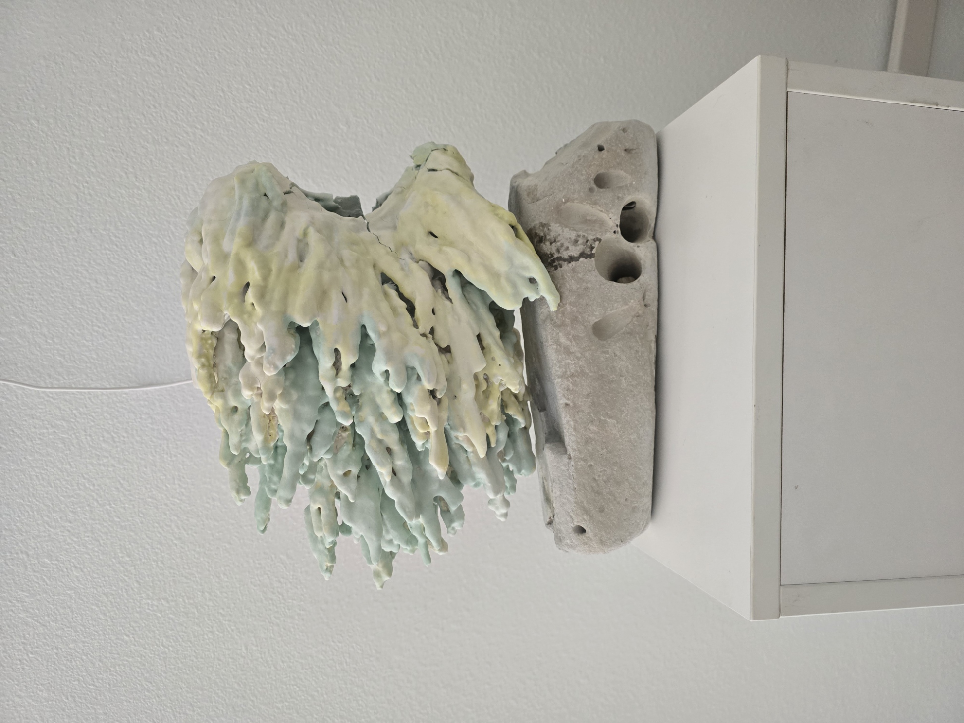 Coral-form ceramic sculpture on stone base