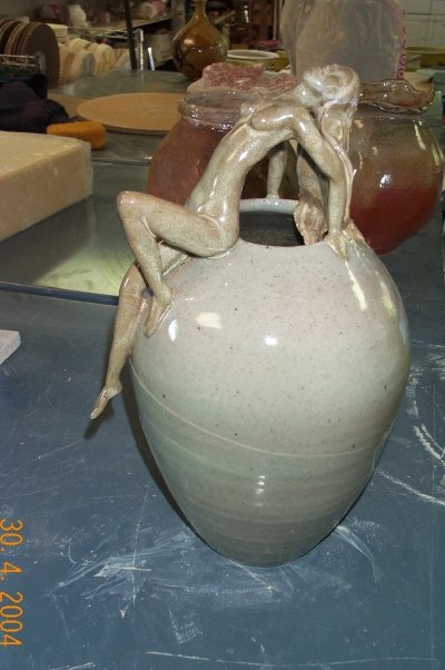 Seated figure on stoneware jar
