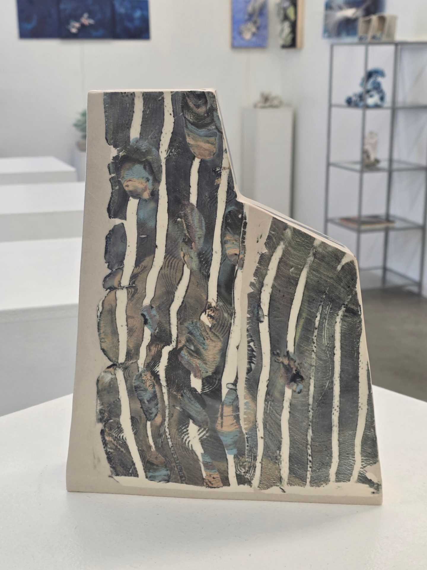 Striped ceramic sculpture in gallery