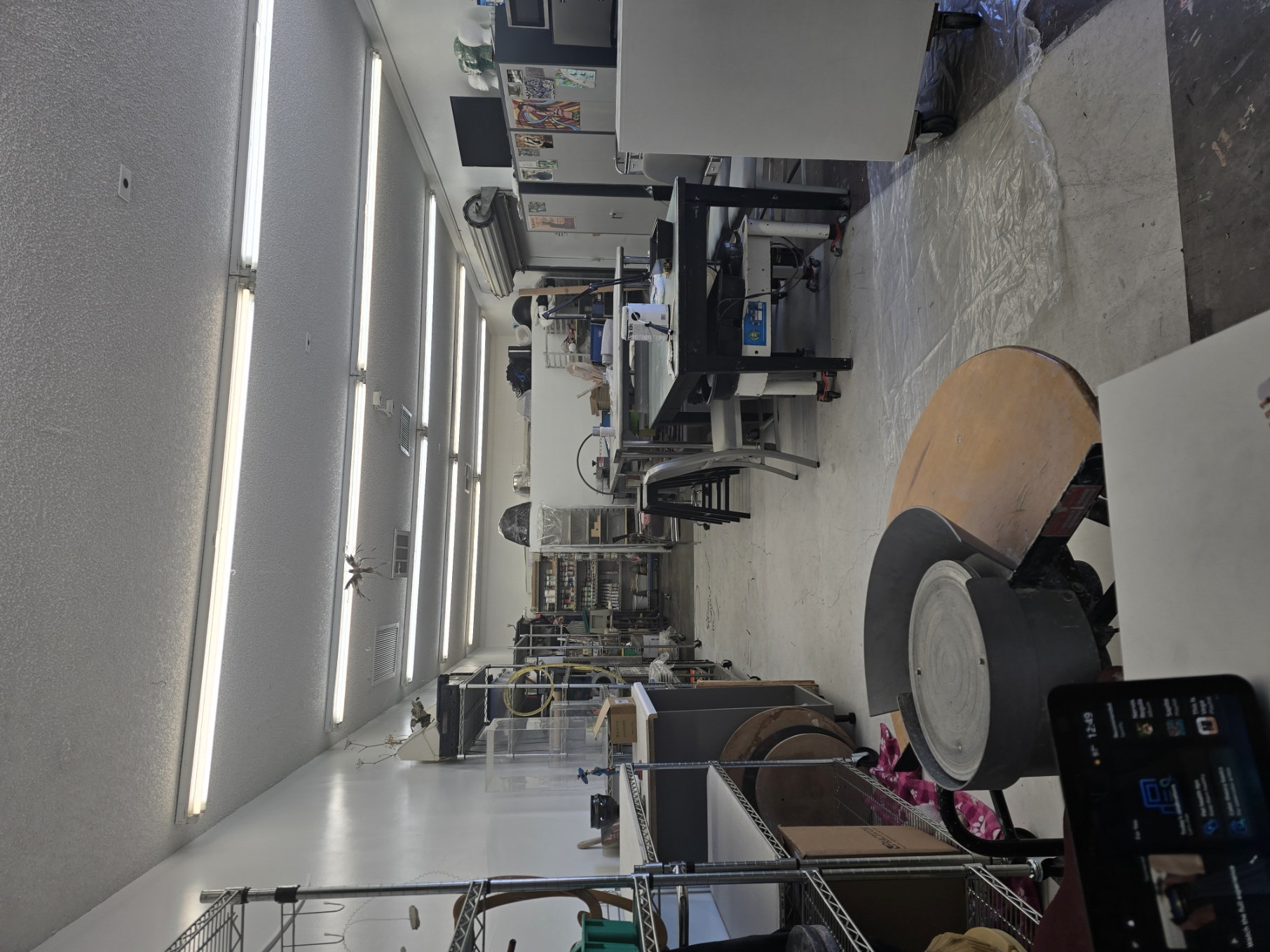Inside the White Rabbit working studio with wheel, tables, and shelving