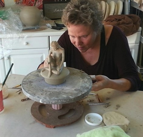 Morgan sculpting a figure at the wheel