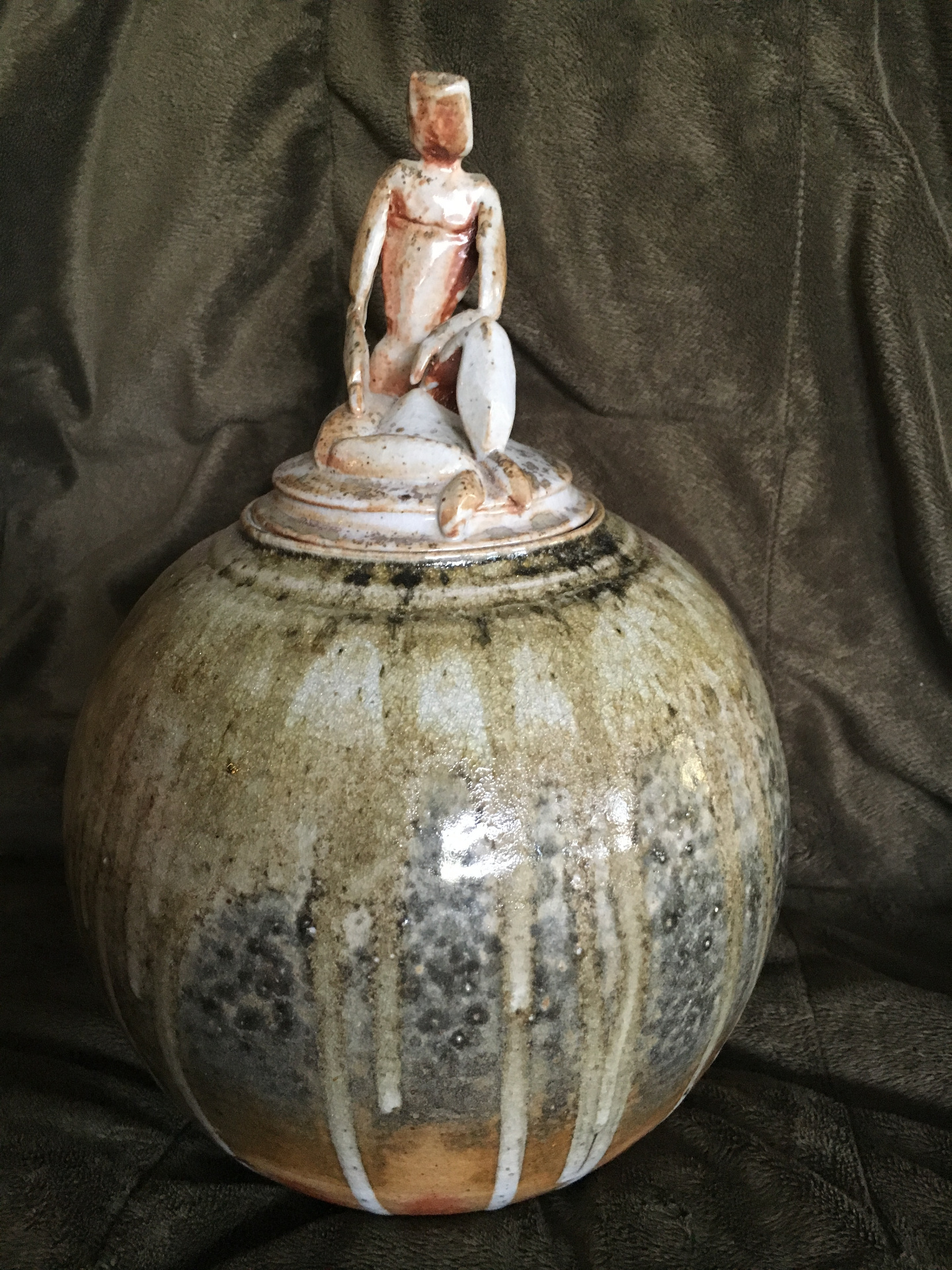 Lidded jar with seated figure finial