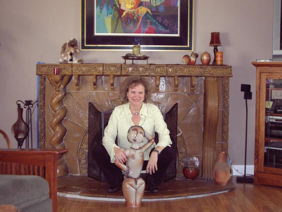 Morgan with ceramic figure at fireplace